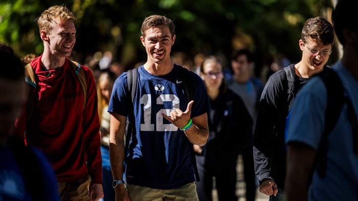 BYU students smiling and walking on campus.